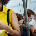 Young woman using a smartphone in a subway.