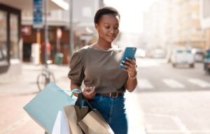 Woman on phone with shopping bags