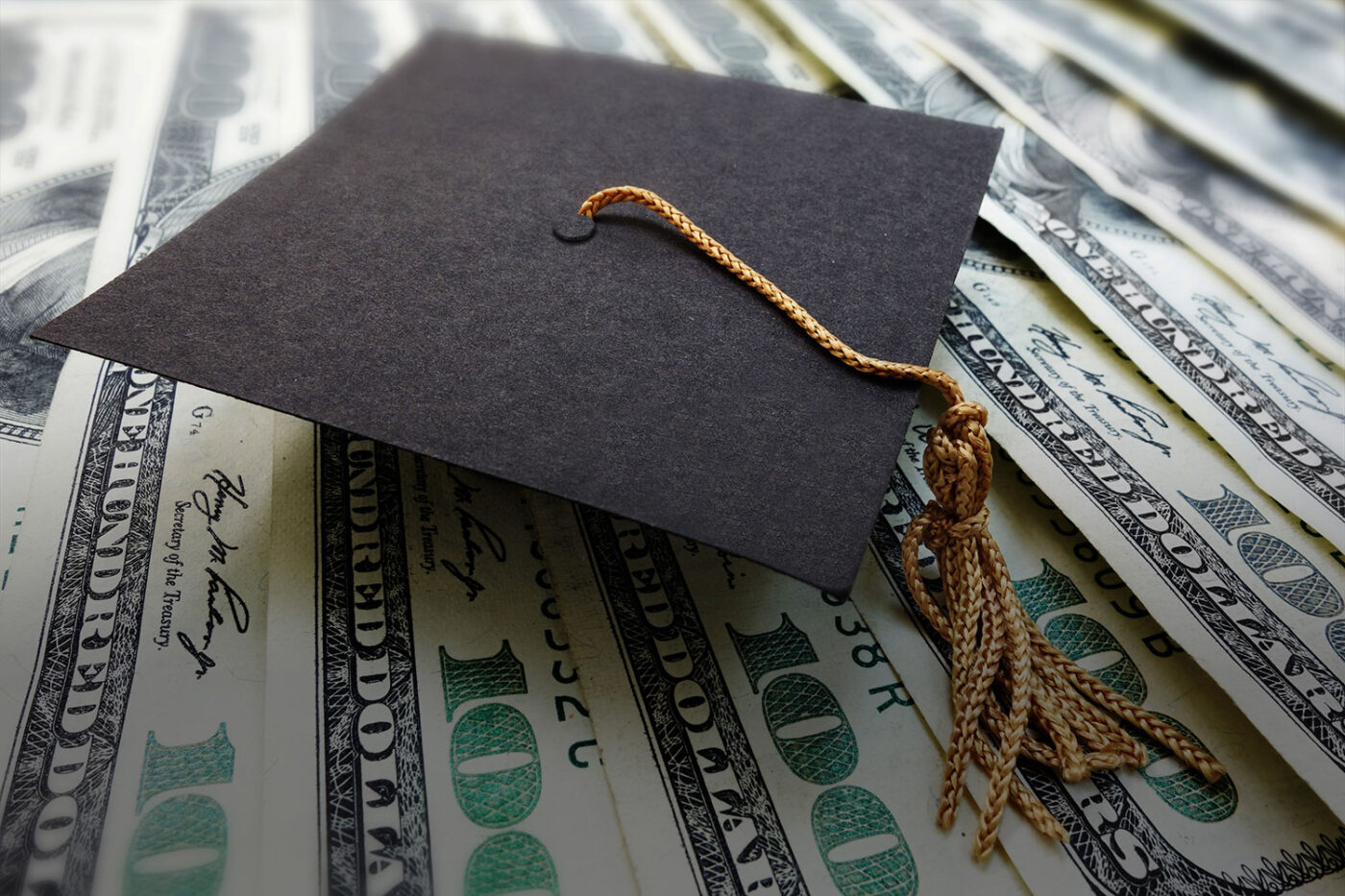 Graduation cap on top of money