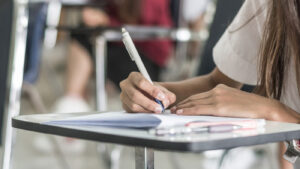 Student filling out application at desk